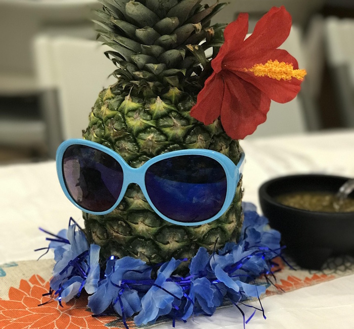 pineapple with sunglasses, flower and lei